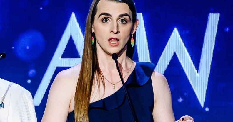 Zooey Zephyr, wearing a single-strap blue dress, speaking during the GLAAD Media Awards.