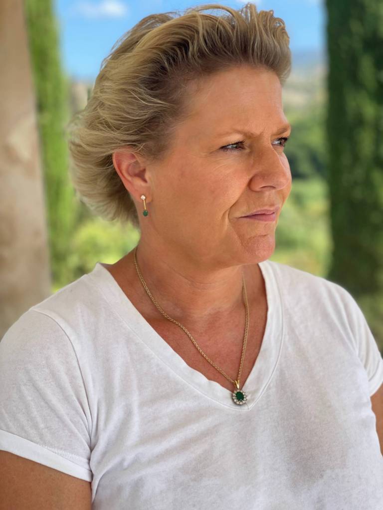 Doctor Helen Webberley, founder of online trans healthcare clinic GenderGP, wears a white shirt as she stands outside for a photo