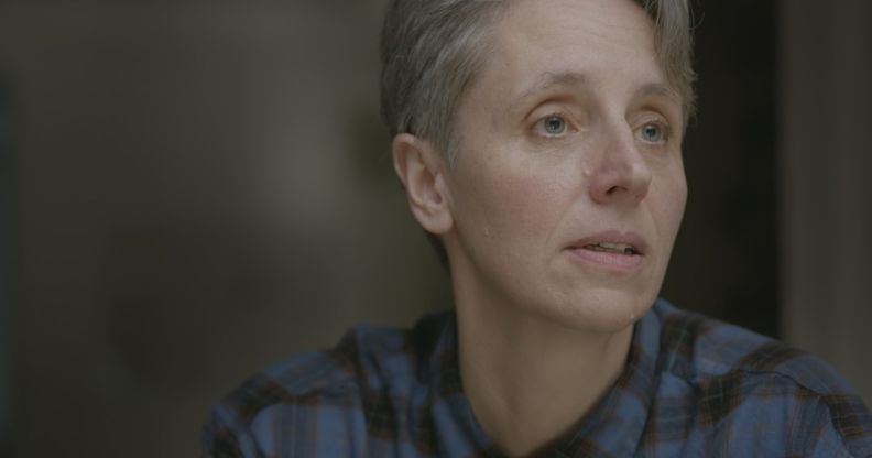 A still of anti-trans campaigner Kathleen Stock wearing a blue plaid shirt as she looks off screen from the Channel 4 documentary Gender Wars