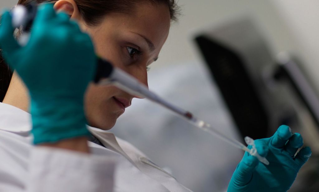 Marina Kemelman, Research Associate at the AIDS Vaccine Design and Development Laboratory, collects bacteria transfected with DNA as part of research at the laboratory's campus.