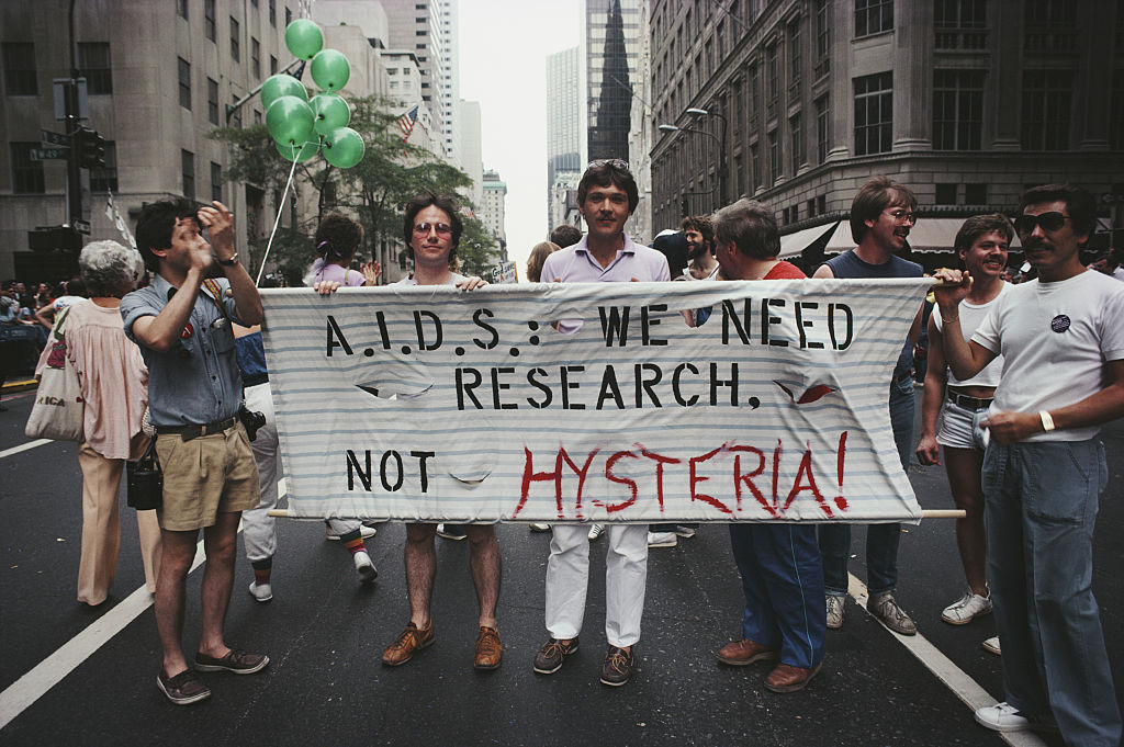 Marchers on a Gay Pride parade through Manhattan, New York City, carry a banner which reads 'A.I.D.S.: We need research, not hysteria!' 