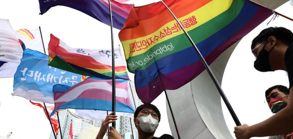 People in South Korea hold up a variety of LGBTQ+ flags in a protest against hatred towards the LGBTQ+ community on International Day Against Homophobia, Transphobia and Biphobia