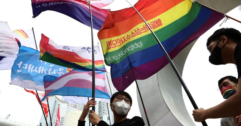 People in South Korea hold up a variety of LGBTQ+ flags in a protest against hatred towards the LGBTQ+ community on International Day Against Homophobia, Transphobia and Biphobia