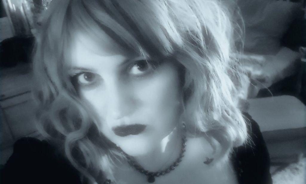 Mélanie, a Princess Diana stan, pictured in a black and white selfie wearing a tiara.