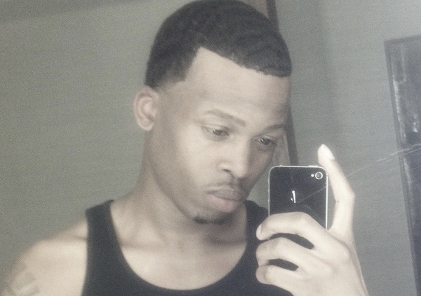 Gemmel Moore pictured in a selfie. He is seen holding a phone.