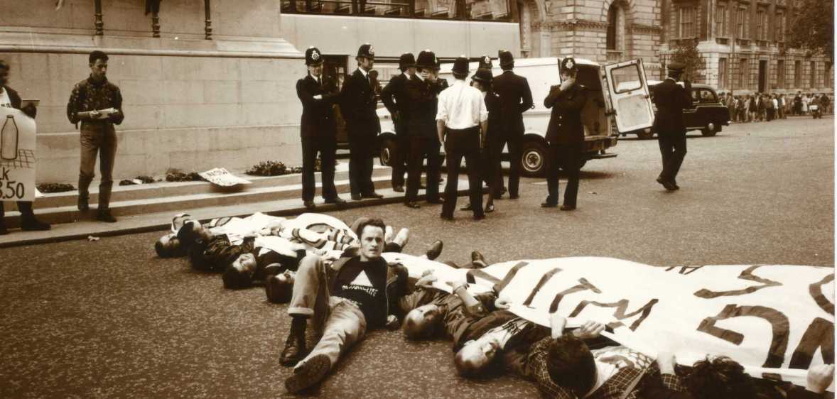 Paul Burston lying on the ground during an ACT UP protest.