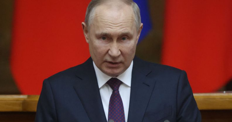Russia president Vladimir Putin, who has led a crackdown on LGBTQ+ people and so-called 'foreign agents', wears a suit and tie as he speaks to people off camera