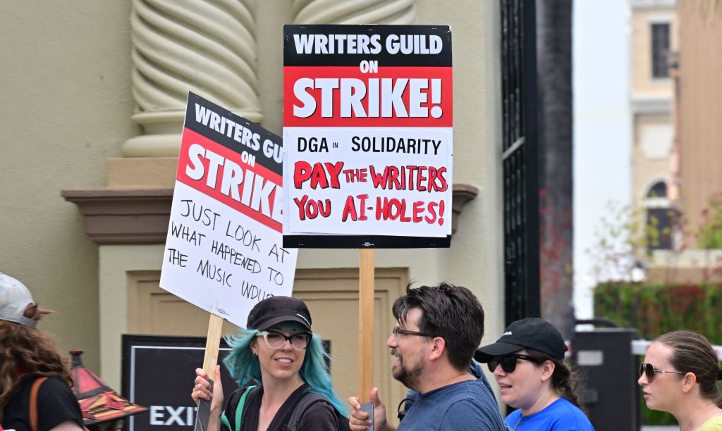 Writers hold signs while picketing in front of Paramount Studios in Los Angeles, California on May 15, 2023. 