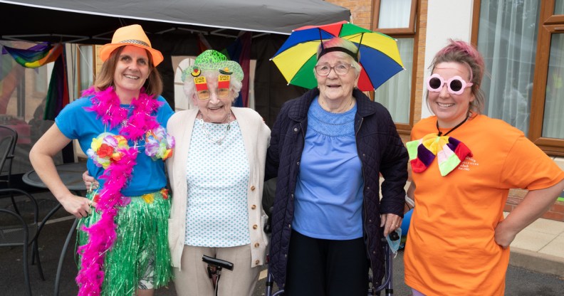 Four people wear rainbow-coloured items to celebrate Silver Pride at Fairway View care home in Nottingham