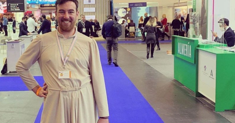 This is an image of Chris King from Lightning Travel Recruitment. They are wearing a white dress and are standing in what looks like a conference hall.