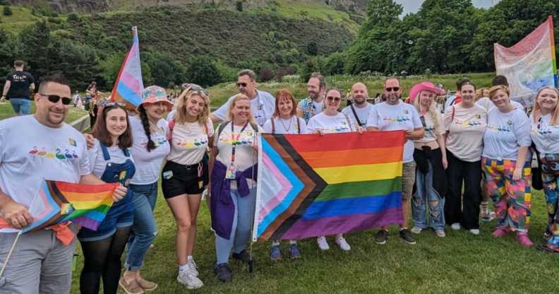 Edinburgh Zoo staff at Edinburgh Pride holding flag