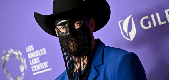 Gay country musician Orville Peck postpones tour citing mental and physical health reasons.
