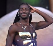 Lil Nas X performs at Glastonbury in a gold-pleated chest piece.