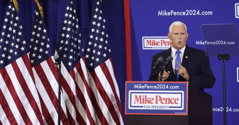 Former vice president Mike Pence stands at a podium reading "Mike Pence 2024" as he launches his presidential bid