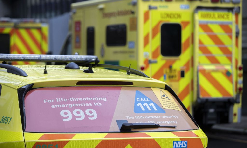 A set of NHS ambulance vehicles parked near a local clinic.