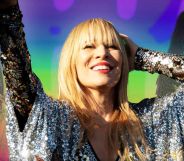 Natasha Bedingfield performing at Mighty Hoopla against a rainbow pride background.