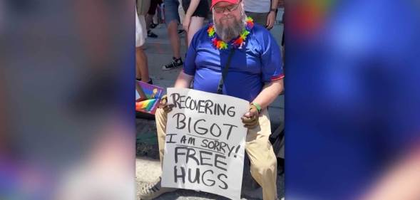 Man holds 'recovering bigot' sign at Denver Pride