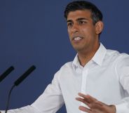 Rishi Sunak at a press conference in a white shirt.