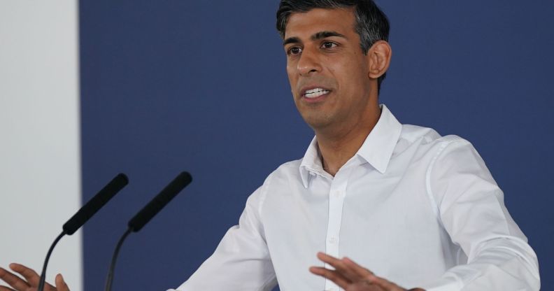 Rishi Sunak at a press conference in a white shirt.
