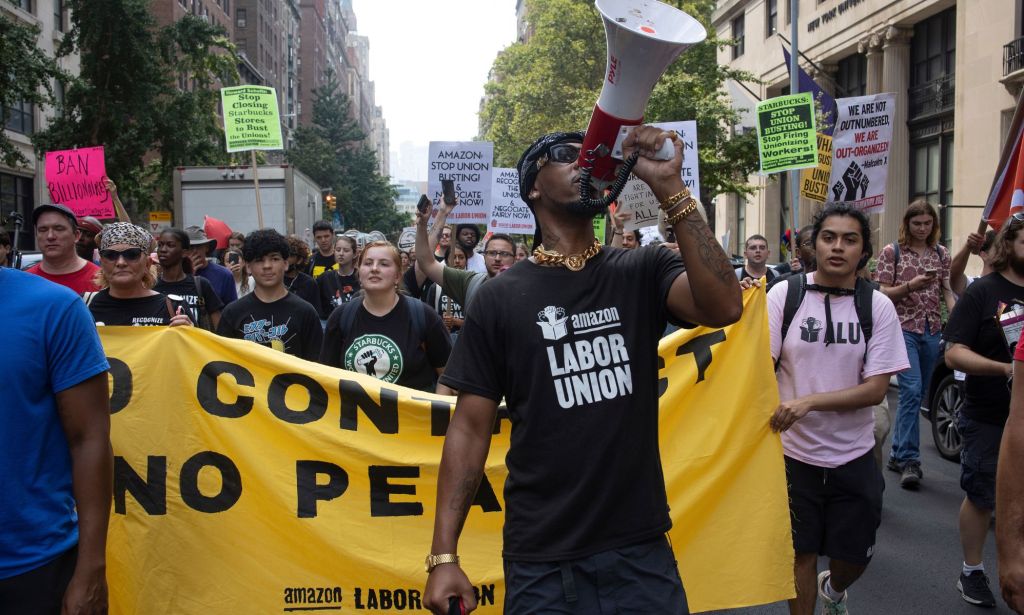 Union workers protest unfair labour laws and union busting during a labor day march.