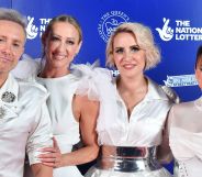 British bop band steps in white and silver outfits.