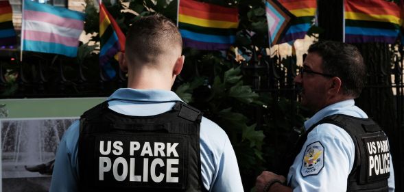 Police officers wearing designated vests stand around the Stonewall National Monument.