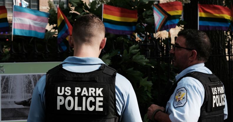 Police officers wearing designated vests stand around the Stonewall National Monument.