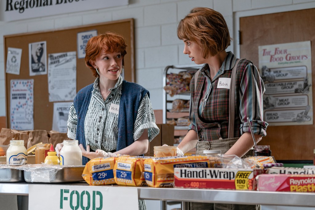 Amybeth McNulty as Vickie (L) and Maya Hawke as Robin Buckley (R) in Stranger Things. 