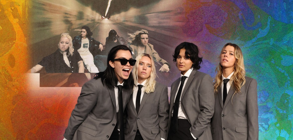 An image of band The Aces wearing grey suit blazers, black trouser and black ties, while standing against a colourful background and the cover of their third album I've Loved You For So Long.