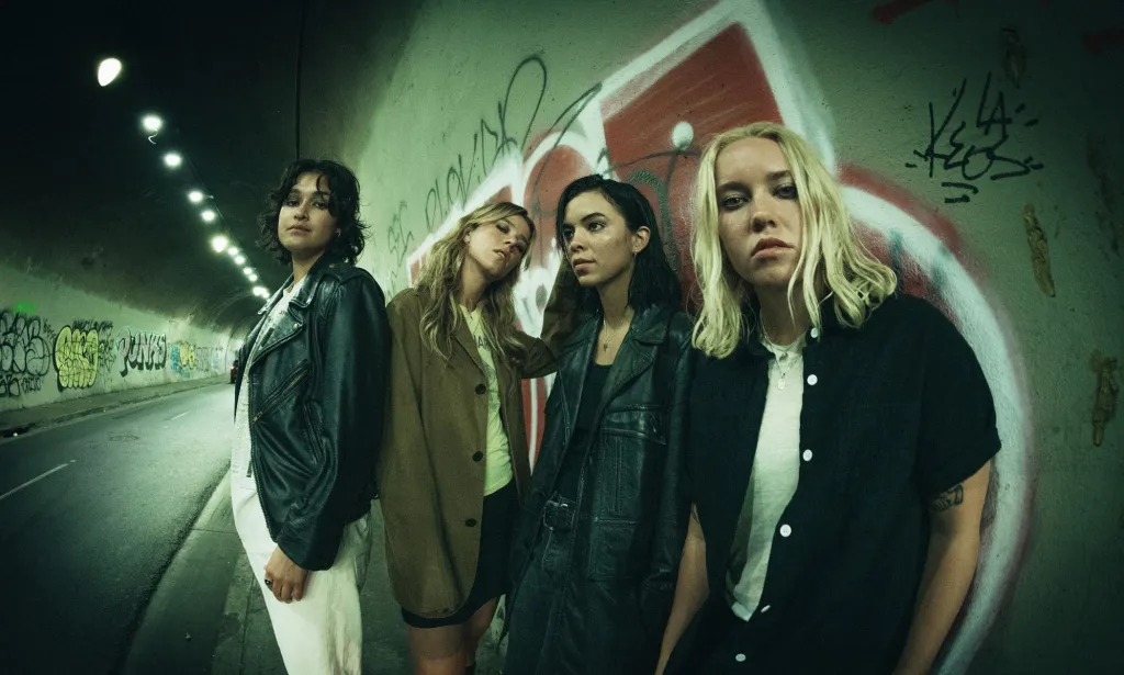 US Band The Aces stand in a tunnel for a promotional photo for their album I've Loved You For So Long.