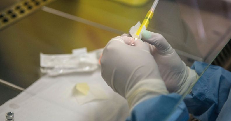 A medical professional holding a needle ready to administer a vaccine.