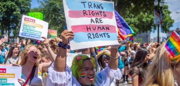 A person holds up a sign reading "trans rights are human rights" at a Pride parade in Portland, Oregon in 2019