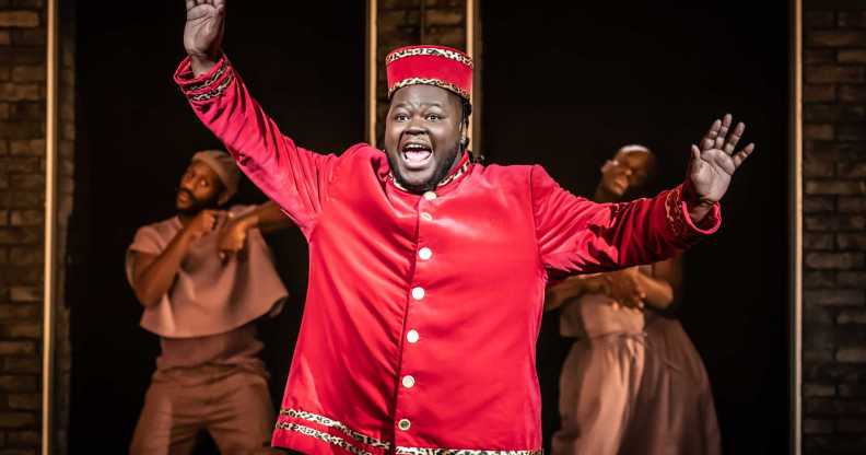Kyle as Usher, a fat Black man wearing a red theatre usher costume