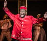 Kyle as Usher, a fat Black man wearing a red theatre usher costume