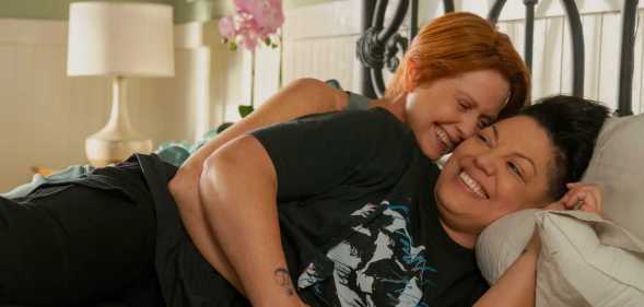 Cynthia Nixon as Miranda cuddling Sara Ramirez as Che Diaz in bed in season two of And Just Like That