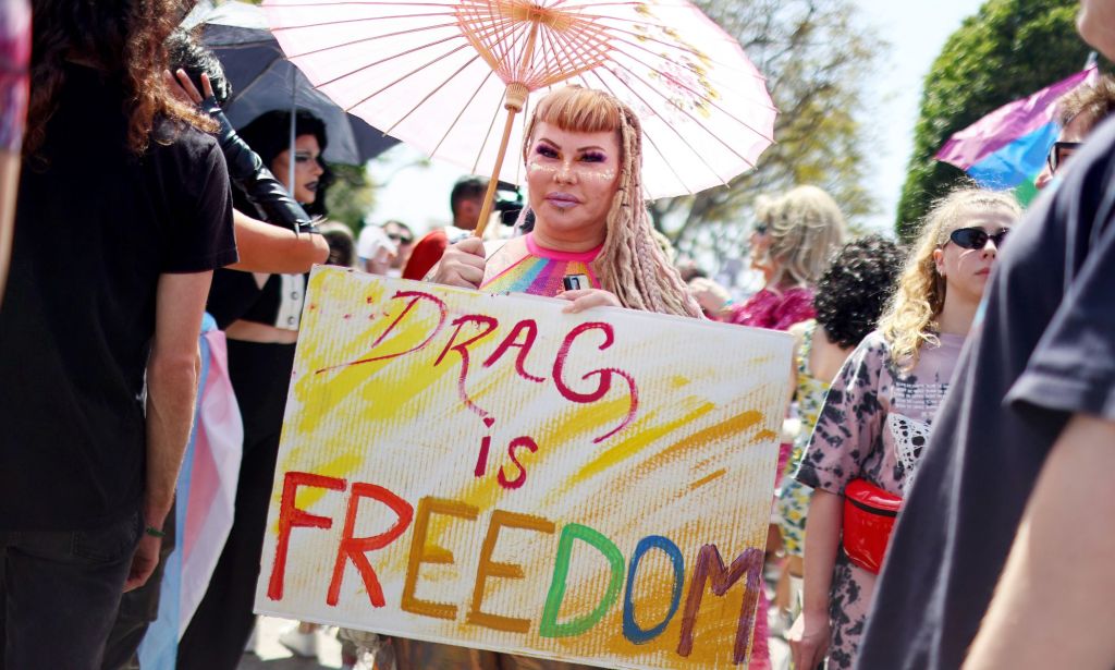 A person holds up a sign reading 'drag is freedom' amid a protest against surging anti-LGBTQ+ bills in the US like Tennessee's drag ban