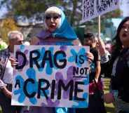 A person holds up a sign reading 'drag is not a crime' amid a protest against surging anti-LGBTQ+ bills in the US like Tennessee's drag ban