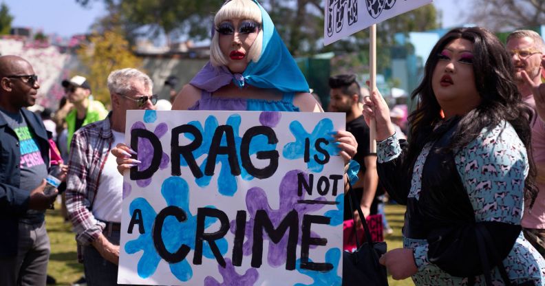 A person holds up a sign reading 'drag is not a crime' amid a protest against surging anti-LGBTQ+ bills in the US like Tennessee's drag ban