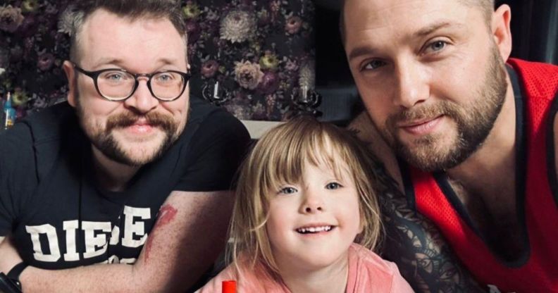 Ian (L) with his husband Darryl (R) and their daughter Aspen (C).