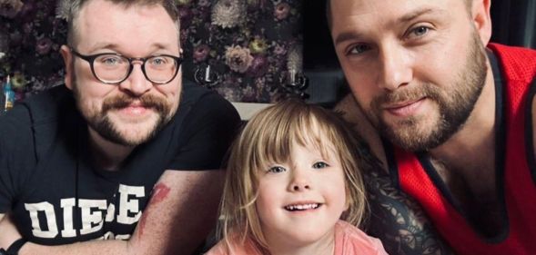Ian (L) with his husband Darryl (R) and their daughter Aspen (C).
