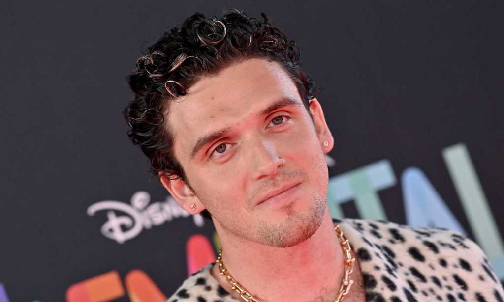 Pop singer Lauv wearing a spotted shirt with short dark hair.