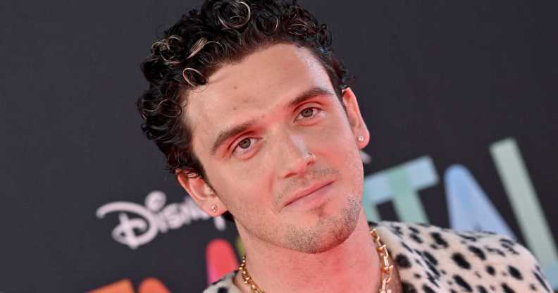 Pop singer Lauv wearing a spotted shirt with short dark hair.