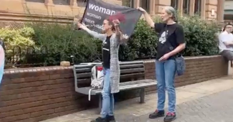 Two people at an anti-trans protest in Lincoln