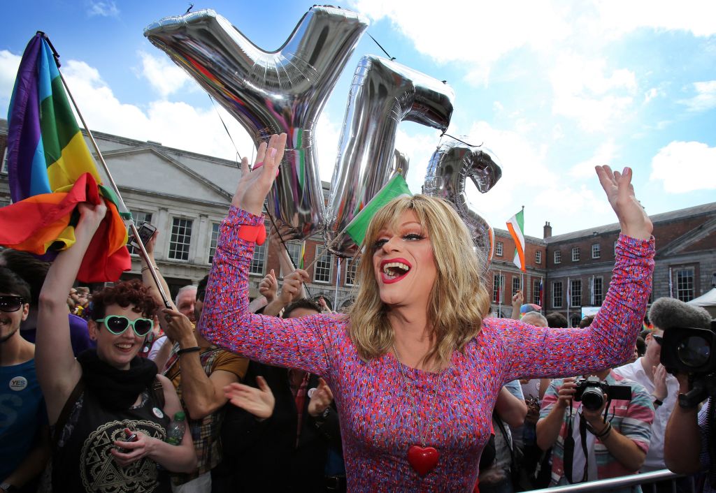 Drag queen and gay rights activist, Rory O'Neill, also known by his stage name Panti raises her arms by supporters for same-sex marriage at Dublin Castle as they wait for the result of the referendum on May 23, 2015.