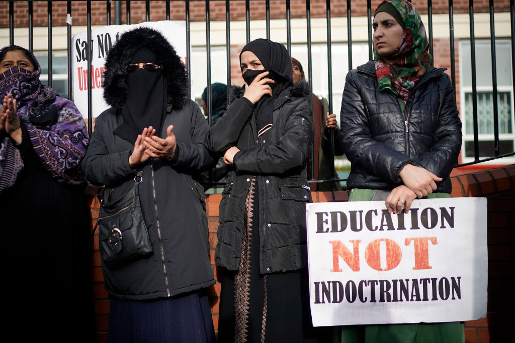 Parents, children and  protestors demonstrate against the 'No Outsiders' programme, which teaches children about LGBT rights, at Parkfield Community School on March 21, 2019.