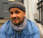 Paul, a mixed-race man with a greying beard, wearing a beanie hat, denim shirt and a scarf