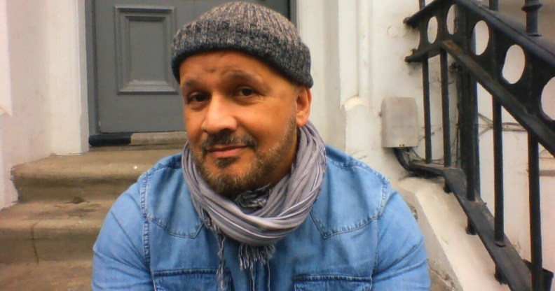 Paul, a mixed-race man with a greying beard, wearing a beanie hat, denim shirt and a scarf