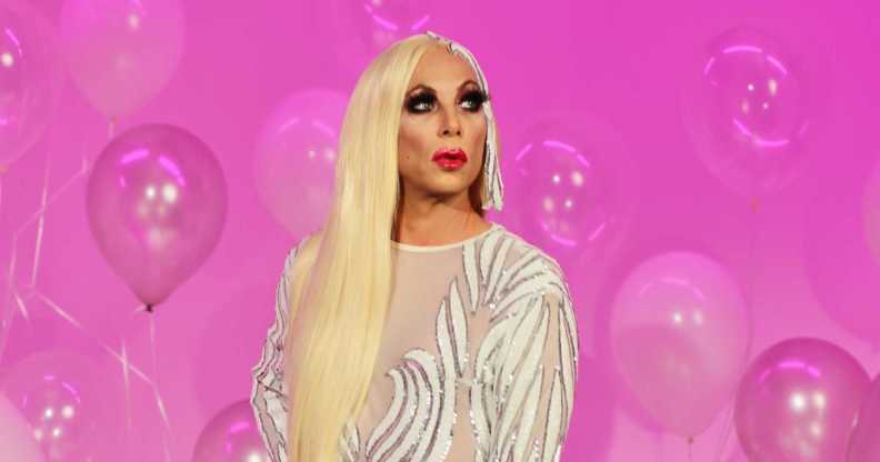 The Sherry Vine Variety Show star Sherry Vine with blonde hair and a silver dress in front of a pink background