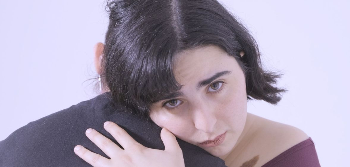 Artist Skaly hugging Quinn Birkholz in the music video for "Redundant".