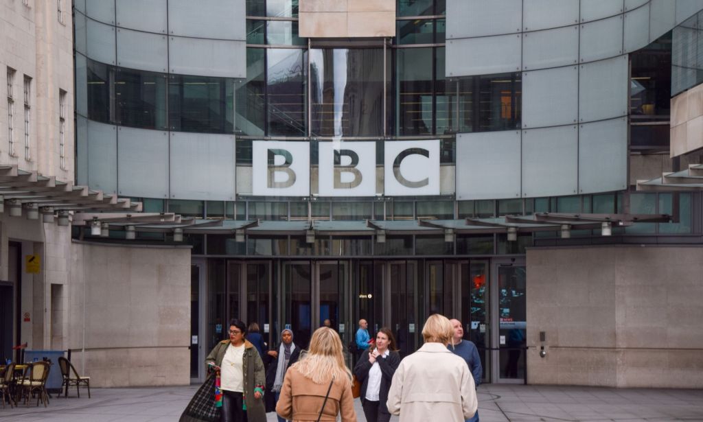 A photo of the outside of the BBC building as people enter and exit the building amid allegations of a new scandal in which an unnamed male BBC presenter solicited sexual pictures of a teen